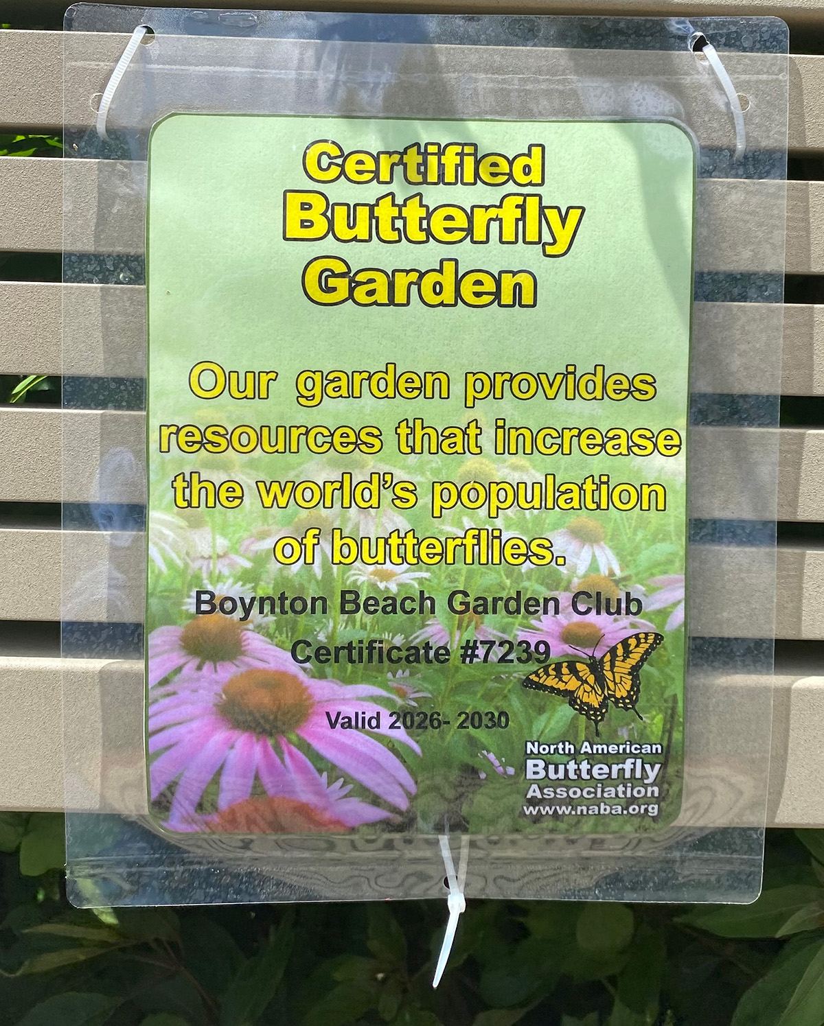 North American Butterfly Association certification placard hanging in the Boynton Beach Garden Club butterfly garden, certificate number 7239